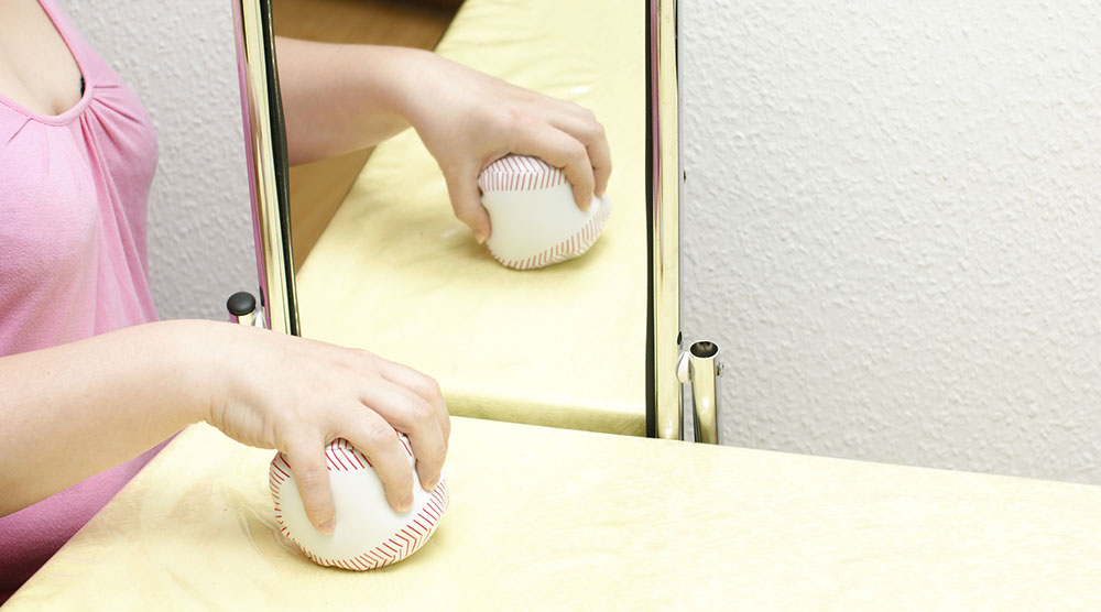 Spiegeltherapie einer Frau mit einem Ball